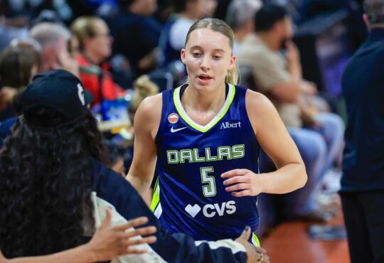 Paige Bueckers (5) and Arike Ogunbowale (24) of the Dallas Wings exchange a high five.