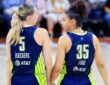 Paige Bueckers and Azzi Fudd talking on the court during the Wings vs. Aces preseason game.