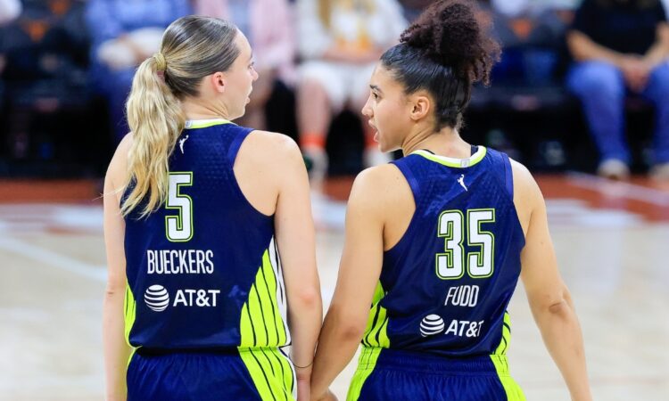 Paige Bueckers and Azzi Fudd talking on the court during the Wings vs. Aces preseason game.