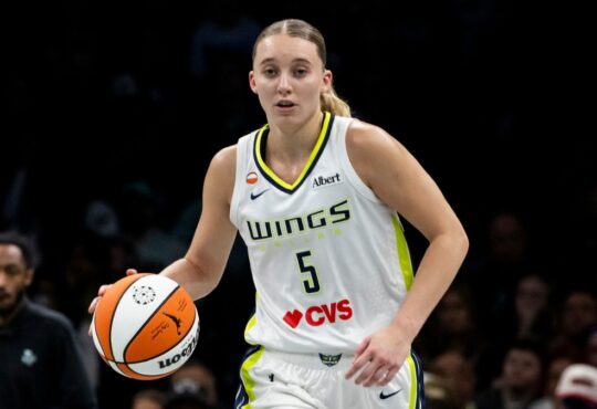 Guard Paige Bueckers dribbling the basketball up the floor in transition during a road game against the New York Liberty.