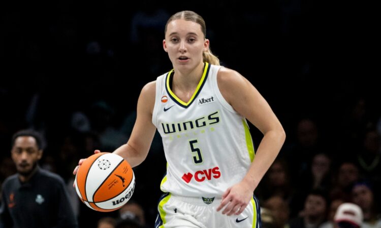 Guard Paige Bueckers dribbling the basketball up the floor in transition during a road game against the New York Liberty.