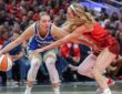 Paige Bueckers (5) of the Dallas Wings dribbles against Lexie Hull (10) of the Indiana Fever at Gainbridge Fieldhouse.