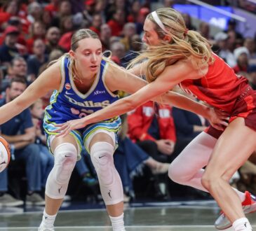Paige Bueckers (5) of the Dallas Wings dribbles against Lexie Hull (10) of the Indiana Fever at Gainbridge Fieldhouse.