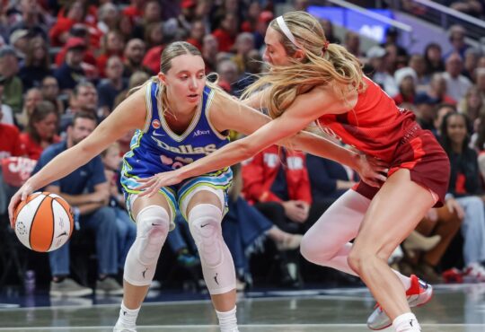 Paige Bueckers (5) of the Dallas Wings dribbles against Lexie Hull (10) of the Indiana Fever at Gainbridge Fieldhouse.