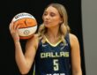 Paige Bueckers of the Dallas Wings posing with a basketball on her shoulder during 2026 Media Day.