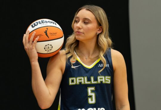 Paige Bueckers of the Dallas Wings posing with a basketball on her shoulder during 2026 Media Day.