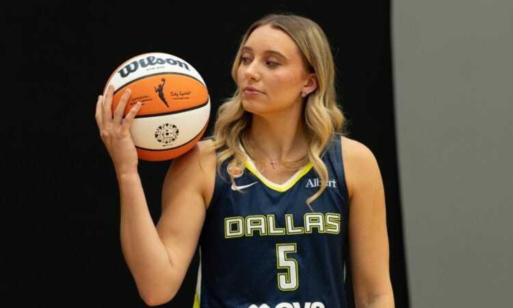 Paige Bueckers of the Dallas Wings posing with a basketball on her shoulder during 2026 Media Day.
