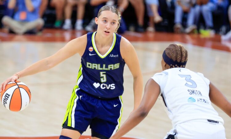 Paige Bueckers of the Dallas Wings dribbles the ball past NaLyssa Smith of the Las Vegas Aces during a preseason game at the Moody Center in Austin.