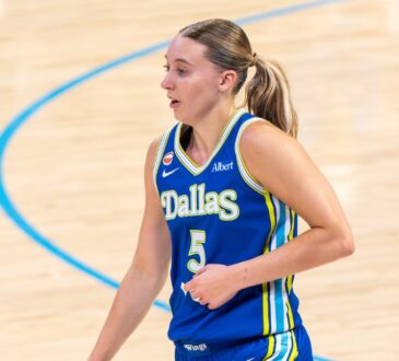 Guard Paige Bueckers keeping her dribble low while scanning the floor against an on-ball Atlanta defender.