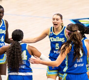Paige Bueckers leads a huddle with teammates Aziaha James, Alanna Smith, Arike Ogunbowale, and Awak Kuier during the home opener against Atlanta.