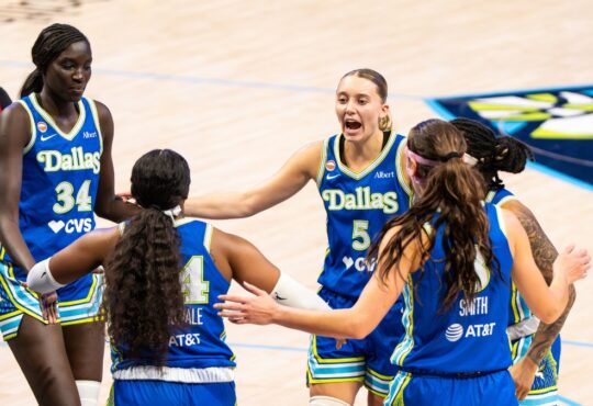 Paige Bueckers leads a huddle with teammates Aziaha James, Alanna Smith, Arike Ogunbowale, and Awak Kuier during the home opener against Atlanta.
