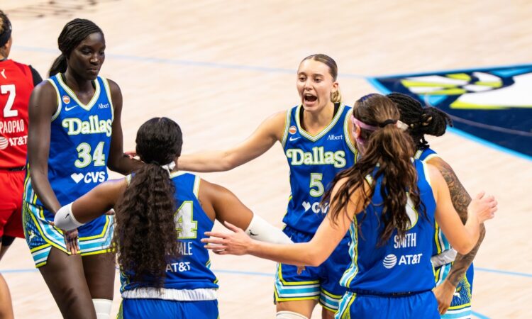 Paige Bueckers leads a huddle with teammates Aziaha James, Alanna Smith, Arike Ogunbowale, and Awak Kuier during the home opener against Atlanta.