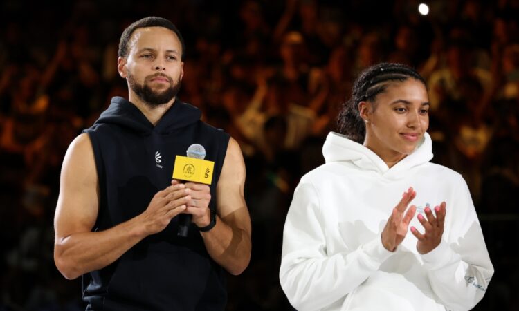 NBA star Stephen Curry and WNBA rookie Azzi Fudd standing together on the court during the 2025 Curry Camp opening training session in Chongqing, China.