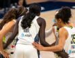 Paige Bueckers, Arike Ogunbowale, Azzi Fudd, Maddy Siegrist, and Awak Kuier huddling on the court against the Minnesota Lynx.