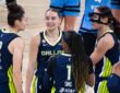 Jessica Shepard, Paige Bueckers, Alanna Smith, Odyssey Sims, and Arike Ogunbowale huddled tightly together on the court discussing a play during a timeout.