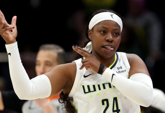 Dallas Wings guard Arike Ogunbowale celebrating a three-point basket during a game against the Seattle Storm at Climate Pledge Arena.