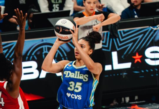 Dallas Wings guard Azzi Fudd shoots over Las Vegas Aces guard Jewell Loyd during a WNBA game at College Park Center in Arlington, Texas, on June 15, 2026.
