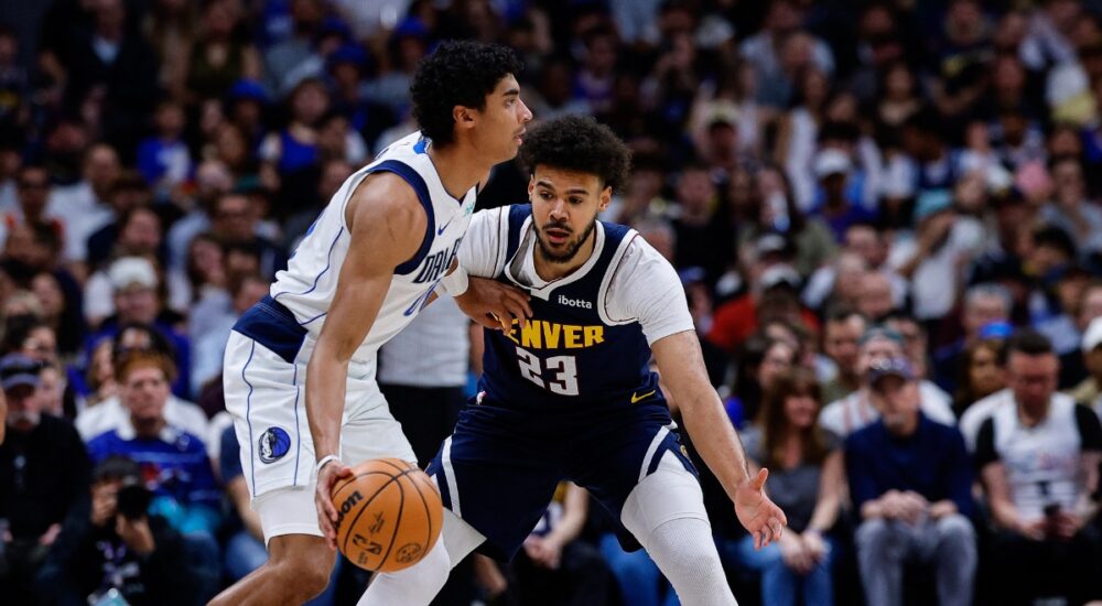 Denver Nuggets forward Cameron Johnson guards Dallas Mavericks guard Max Christie in the first quarter at Ball Arena.