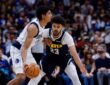Denver Nuggets forward Cameron Johnson guards Dallas Mavericks guard Max Christie in the first quarter at Ball Arena.