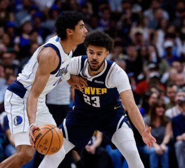 Denver Nuggets forward Cameron Johnson guards Dallas Mavericks guard Max Christie in the first quarter at Ball Arena.