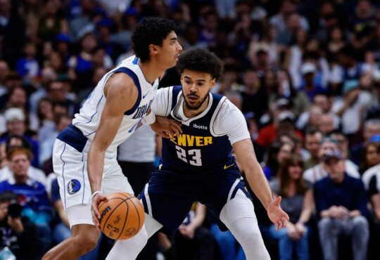 Denver Nuggets forward Cameron Johnson guards Dallas Mavericks guard Max Christie in the first quarter at Ball Arena.