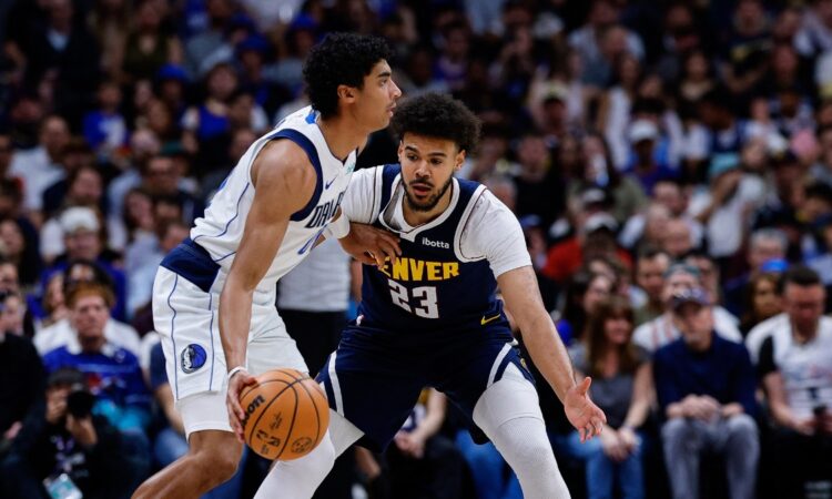 Denver Nuggets forward Cameron Johnson guards Dallas Mavericks guard Max Christie in the first quarter at Ball Arena.