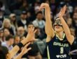 Dallas Wings forward Alanna Smith, wearing a protective face mask, shoots a 3-pointer over Golden State's Janelle Salaün.