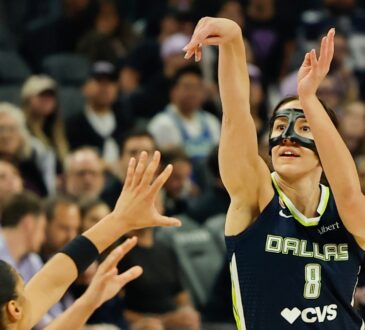 Dallas Wings forward Alanna Smith, wearing a protective face mask, shoots a 3-pointer over Golden State's Janelle Salaün.