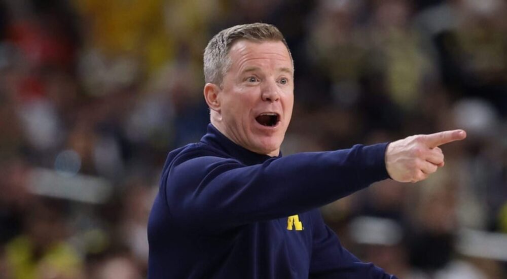Michigan coach Dusty May shouts and points from the sideline during a game.