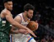 Giannis Antetokounmpo #34 of the Milwaukee Bucks defends Chet Holmgren #7 of the Oklahoma City Thunder at Fiserv Forum.