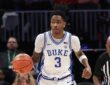 Duke guard Isaiah Evans dribbles up the court in his white No. 3 jersey during the 2025-26 season