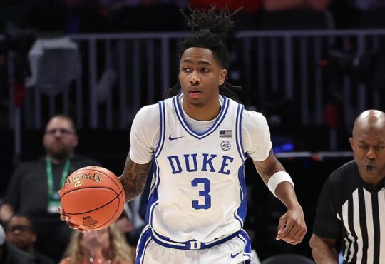 Duke guard Isaiah Evans dribbles up the court in his white No. 3 jersey during the 2025-26 season
