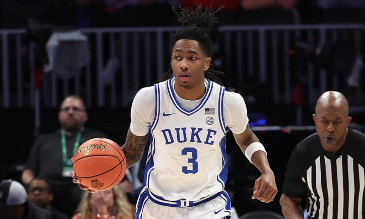 Duke guard Isaiah Evans dribbles up the court in his white No. 3 jersey during the 2025-26 season