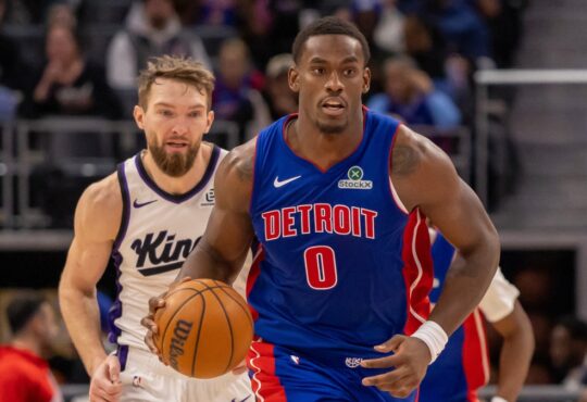 Detroit Pistons center Jalen Duren dribbles the ball up court ahead of Sacramento Kings forward Domantas Sabonis during a game at Little Caesars Arena