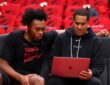 Toronto Raptors assistant coach and Mavericks head coaching candidate Jama Mahlalela reviews film on a laptop with forward Scottie Barnes on the bench