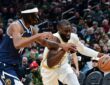 Boston Celtics guard Jaylen Brown controls the ball while Denver Nuggets forward Daron Holmes II defends during the first half at TD Garden