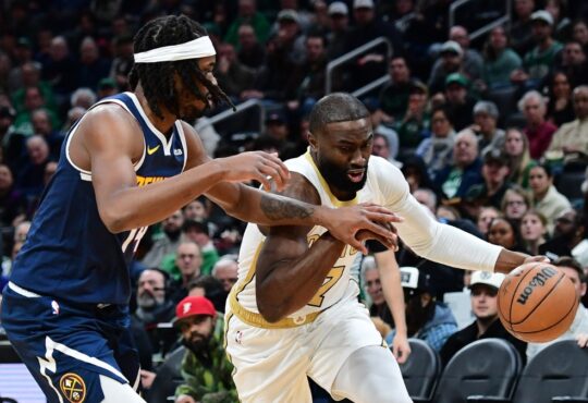 Boston Celtics guard Jaylen Brown controls the ball while Denver Nuggets forward Daron Holmes II defends during the first half at TD Garden