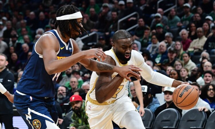 Boston Celtics guard Jaylen Brown controls the ball while Denver Nuggets forward Daron Holmes II defends during the first half at TD Garden