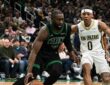 Jaylen Brown #7 of the Boston Celtics drives to the basket against Jeremiah Fears #0 of the New Orleans Pelicans at TD Garden.