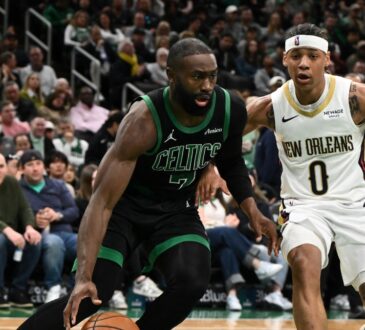 Jaylen Brown #7 of the Boston Celtics drives to the basket against Jeremiah Fears #0 of the New Orleans Pelicans at TD Garden.