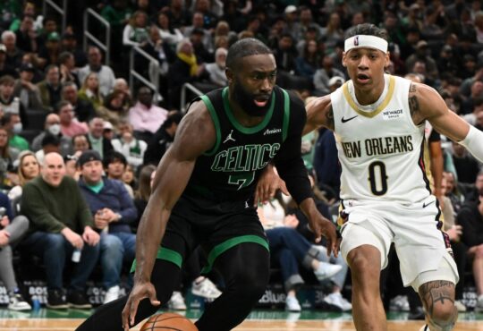Jaylen Brown #7 of the Boston Celtics drives to the basket against Jeremiah Fears #0 of the New Orleans Pelicans at TD Garden.