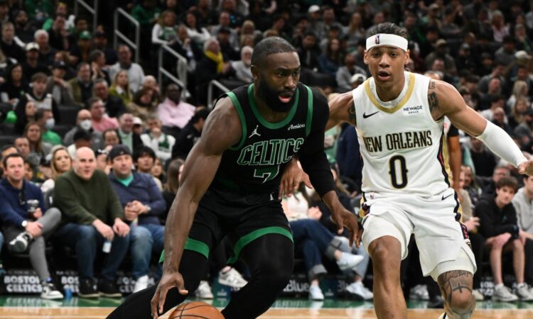 Jaylen Brown #7 of the Boston Celtics drives to the basket against Jeremiah Fears #0 of the New Orleans Pelicans at TD Garden.
