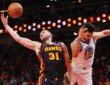 Atlanta Hawks center Jock Landale grabs a rebound past Golden State Warriors center Omer Yurtseven at State Farm Arena.