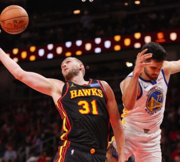 Atlanta Hawks center Jock Landale grabs a rebound past Golden State Warriors center Omer Yurtseven at State Farm Arena.