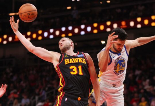 Atlanta Hawks center Jock Landale grabs a rebound past Golden State Warriors center Omer Yurtseven at State Farm Arena.