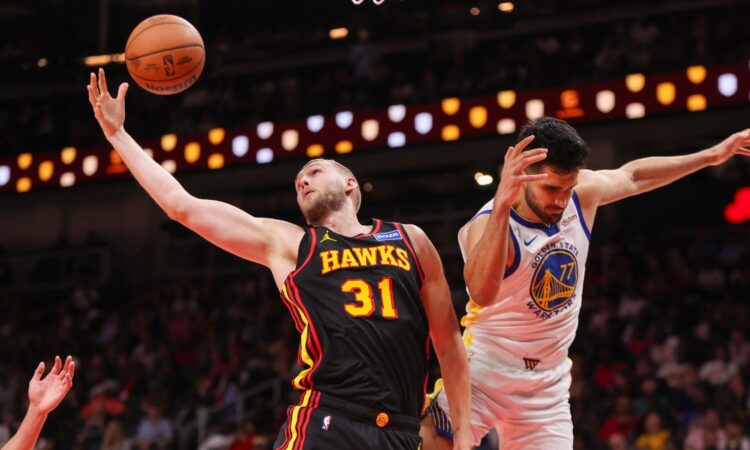 Atlanta Hawks center Jock Landale grabs a rebound past Golden State Warriors center Omer Yurtseven at State Farm Arena.