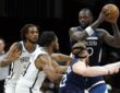 Julius Randle #30 of the Minnesota Timberwolves looks to pass against Cam Thomas #24 and Nic Claxton #33 of the Brooklyn Nets at Barclays Center.