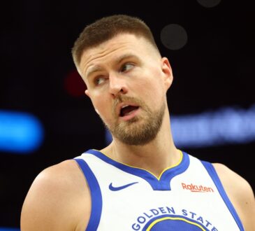 Golden State Warriors center Kristaps Porzingis on the court against the Phoenix Suns during the 2026 NBA play-in tournament at Mortgage Matchup Center in Phoenix.