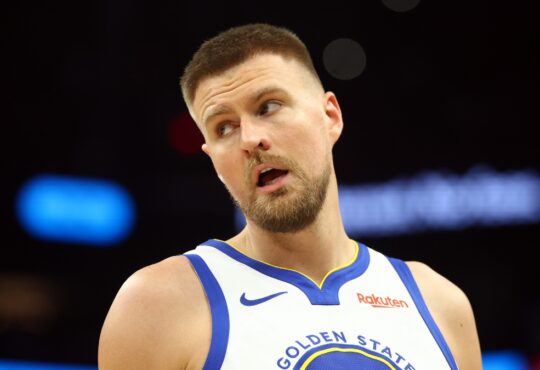 Golden State Warriors center Kristaps Porzingis on the court against the Phoenix Suns during the 2026 NBA play-in tournament at Mortgage Matchup Center in Phoenix.