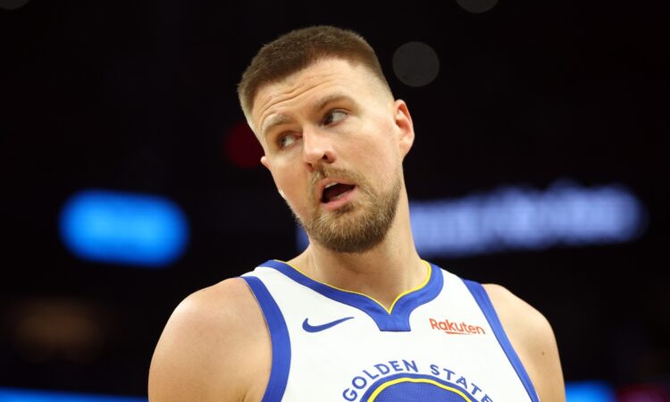 Golden State Warriors center Kristaps Porzingis on the court against the Phoenix Suns during the 2026 NBA play-in tournament at Mortgage Matchup Center in Phoenix.